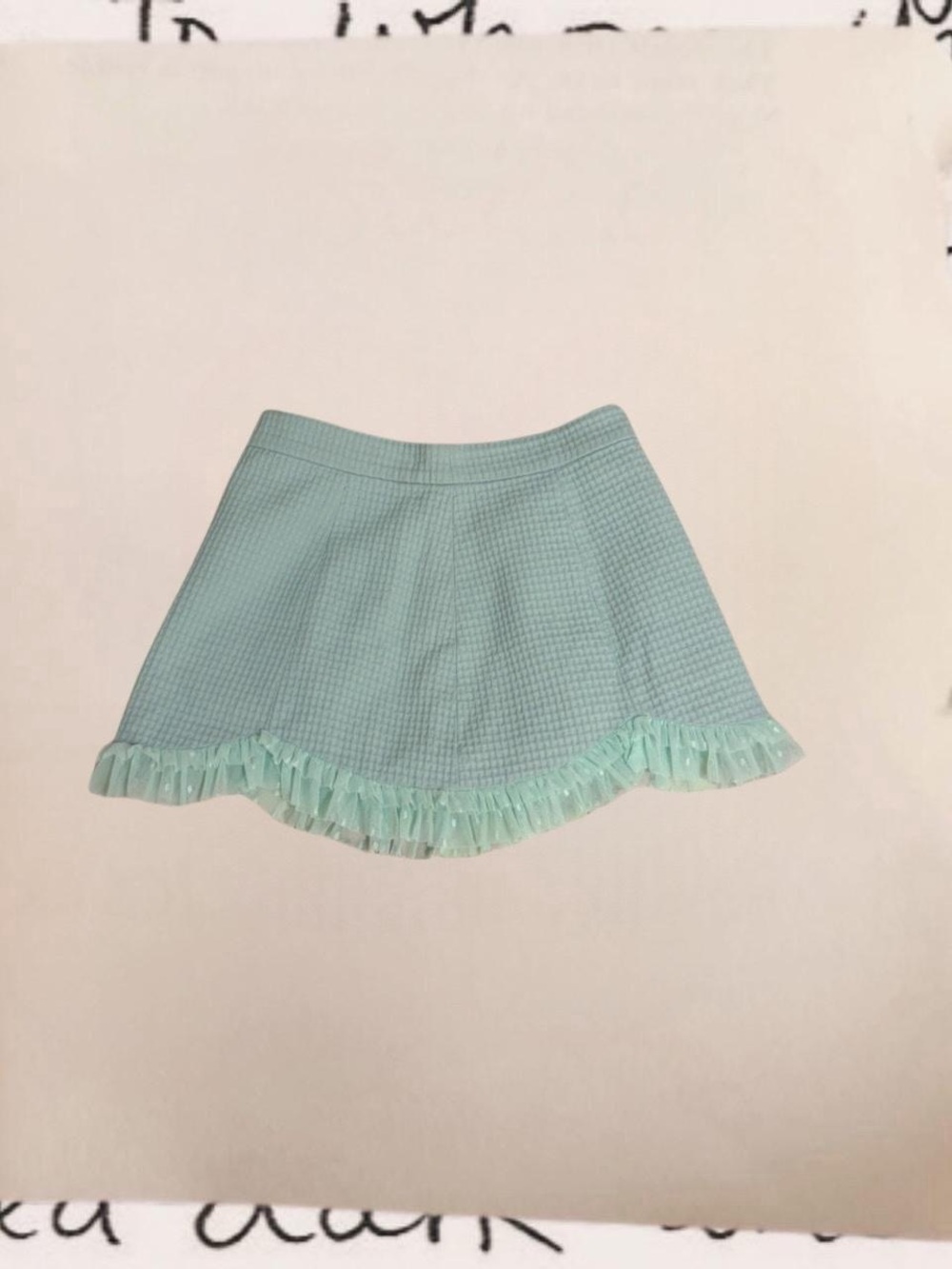 pastel teal mini skirt with sheer polka dot ruffle trim
